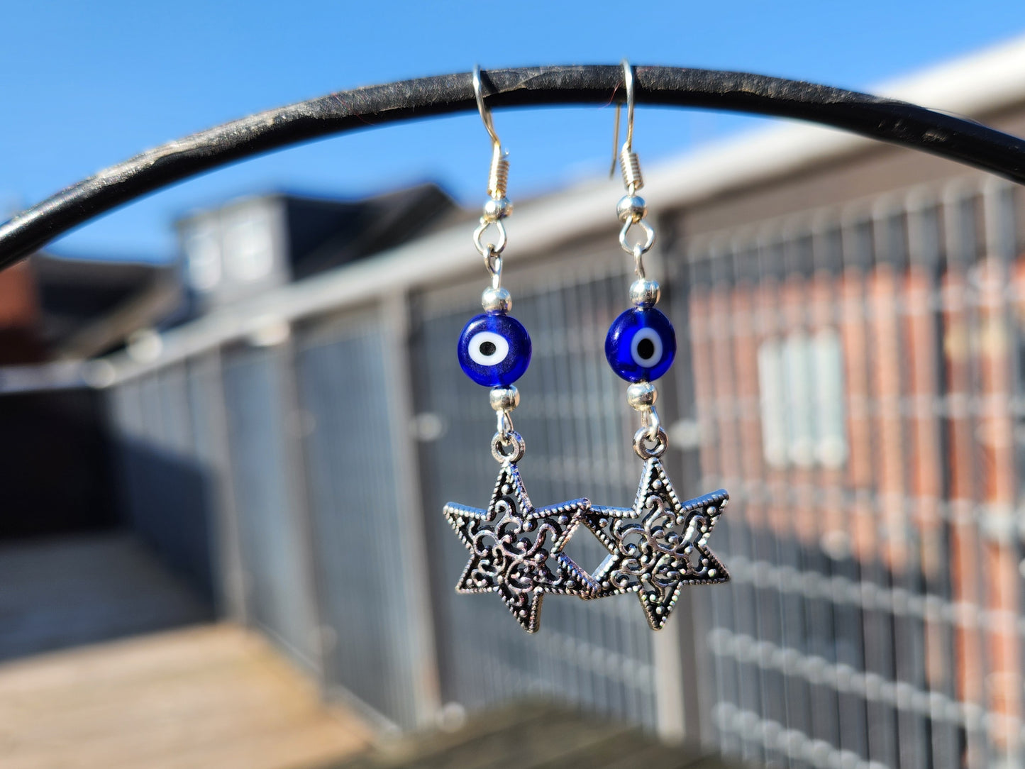 blue evil eye bead silver star earrings
