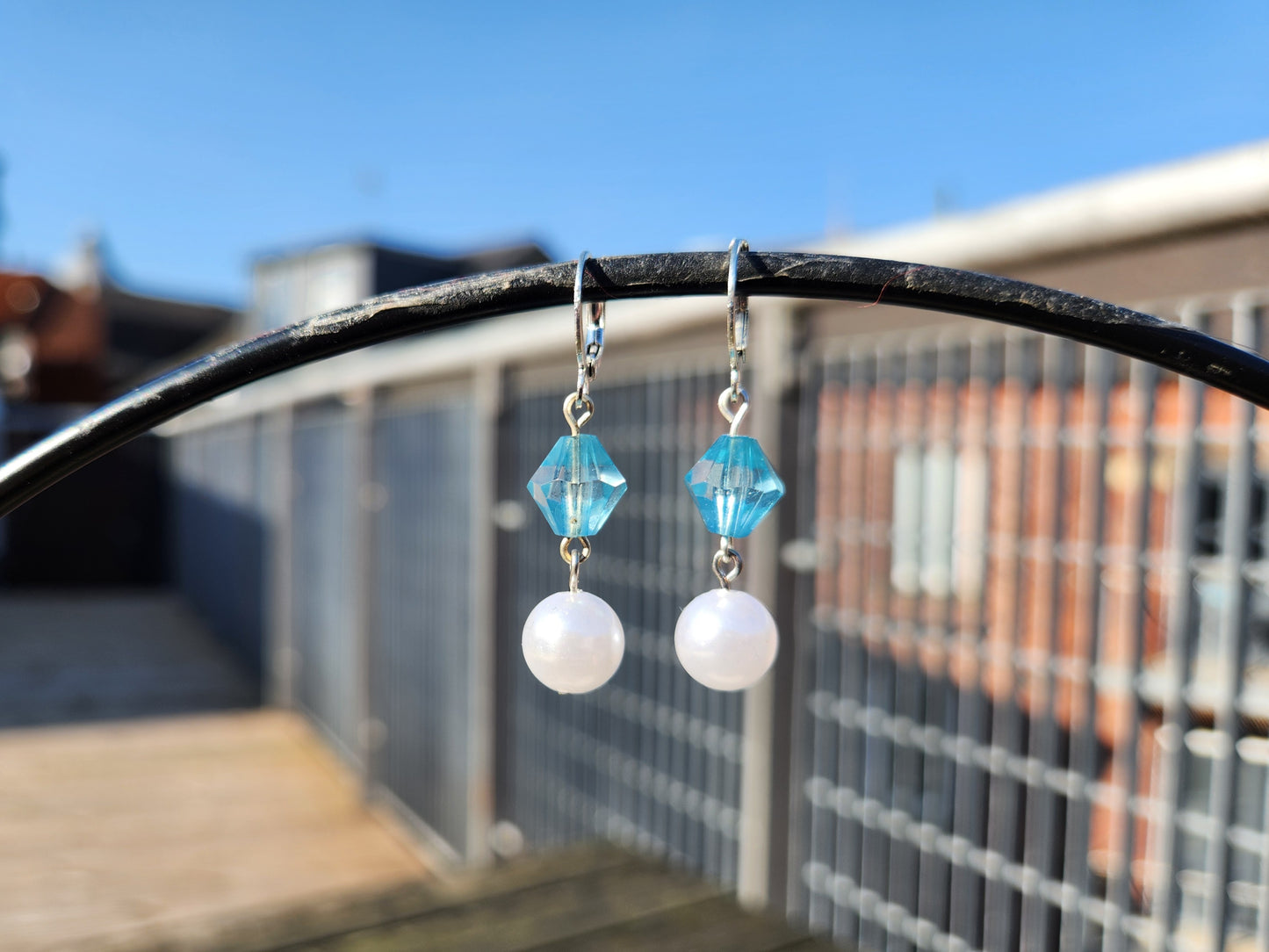 white and blue beaded silver dangle huggie earrings