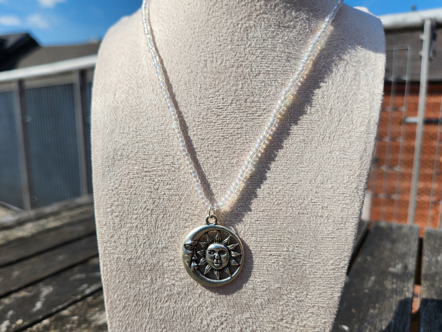 silver celestial pendant iridescent glass bead necklace