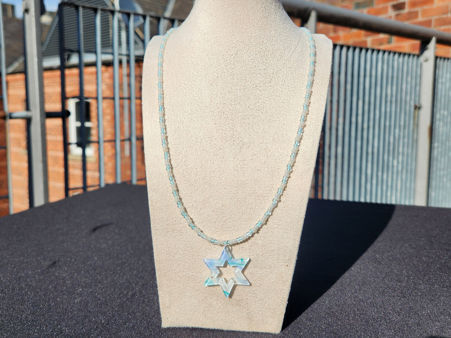 pale blue and cream glass bead star of david pendant necklace