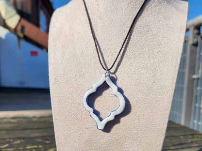 white and blue ornate clay pendant necklace