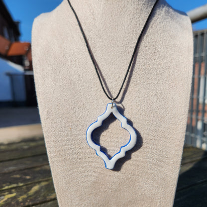 white and blue ornate clay pendant necklace