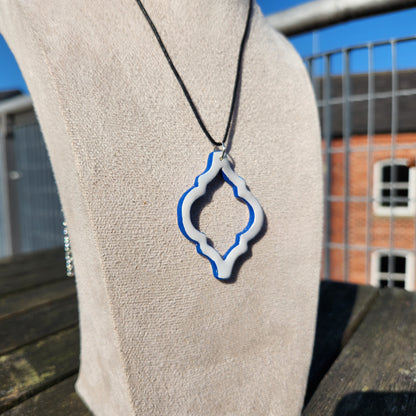 white and blue ornate clay pendant necklace