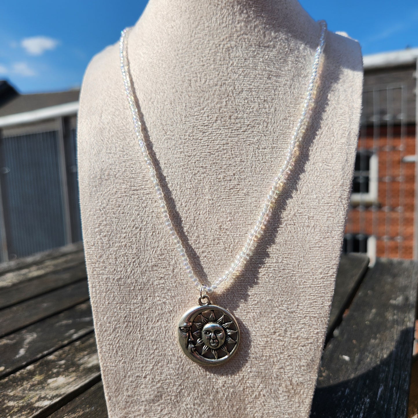 silver celestial pendant iridescent glass bead necklace